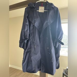 Moncler rain parka with hoodie, details on buttons and sleeves.